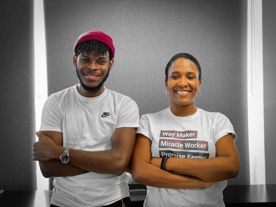 Two founders standing together, arms folded, smiling
